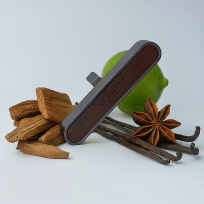 Scentsy product with cinnamon sticks, star anise, and a lime on a light background